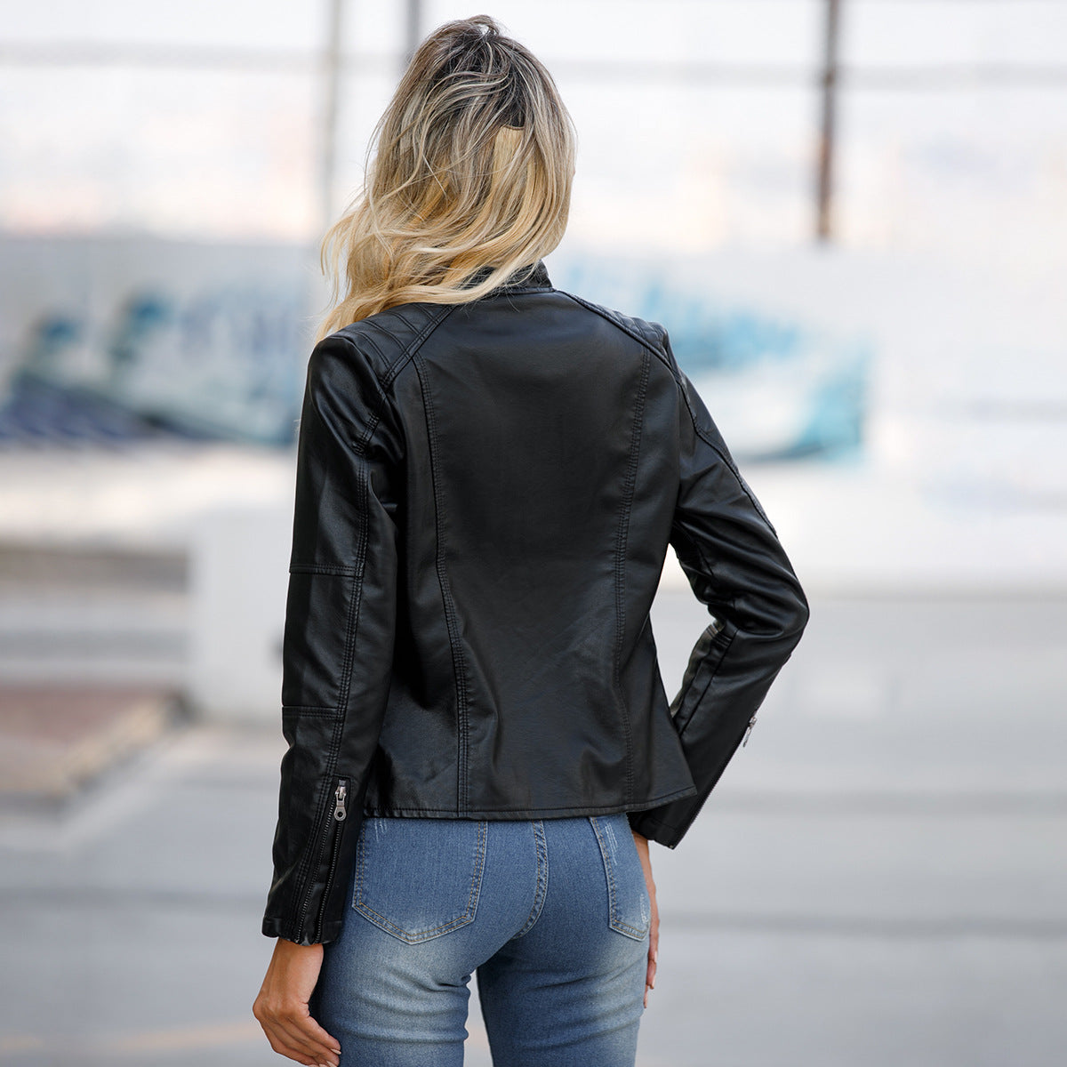 Women's black faux leather jacket with stand-up collar, back view